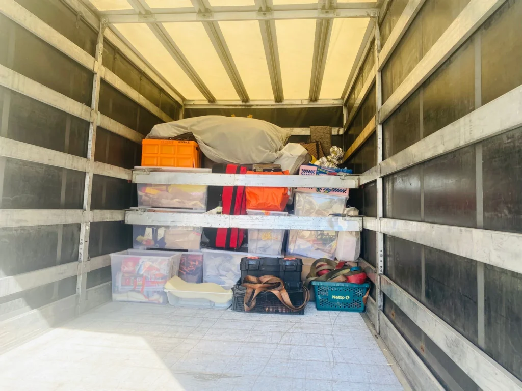 VANonsite student removals with storage boxes, luggage and household items inside a moving van